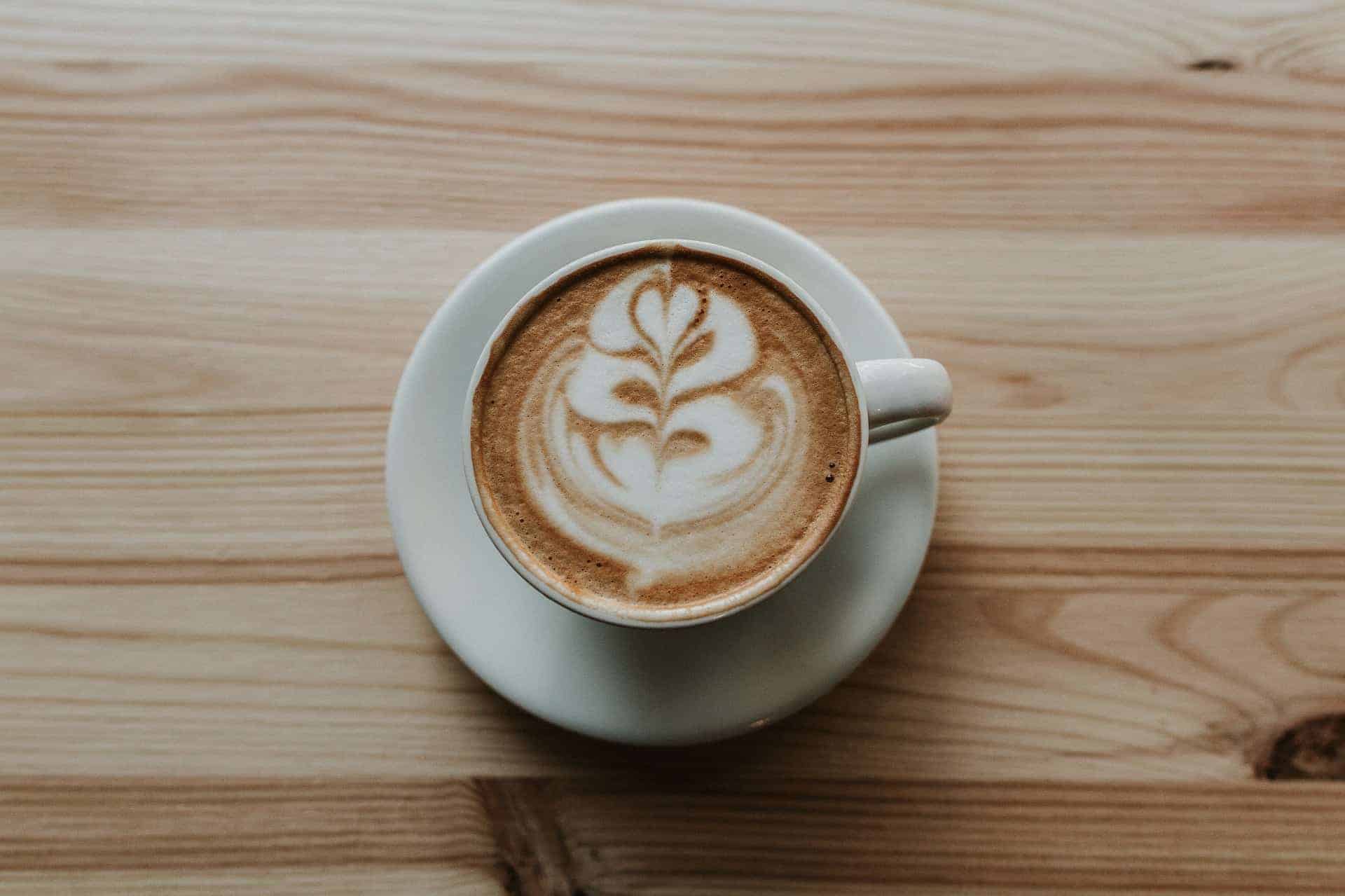 canva coffee in white ceramic teacup on white ceramic suacer